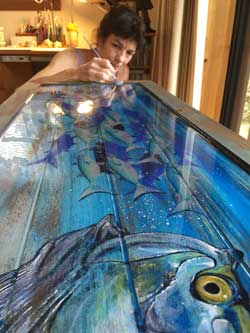 Kathleen Mazzotta paints tarpon table